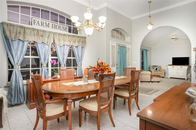 a view of a dining room with furniture and a chandelier