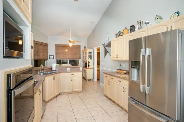 a kitchen with white cabinets and appliances
