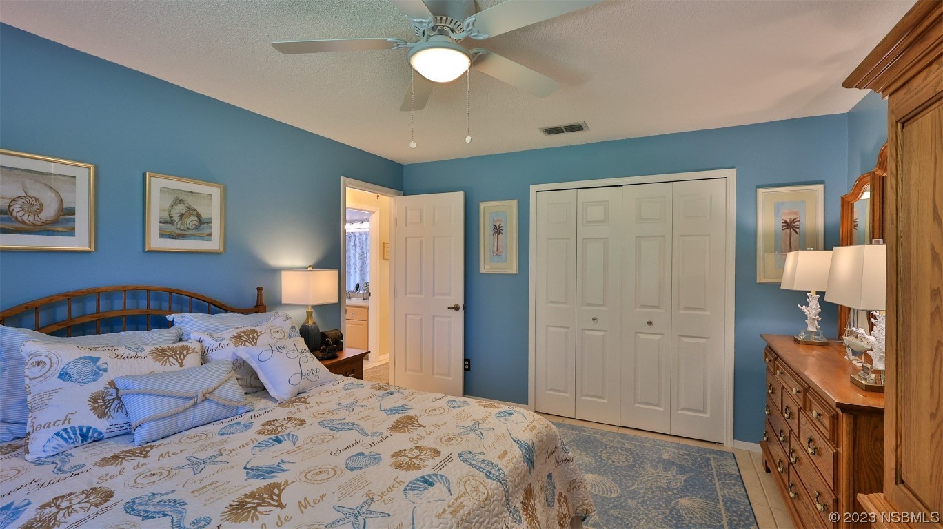 160 Packwood Road Edgewater, FL 32141 - Photo 23 of 31 a bedroom with a bed and a chandelier