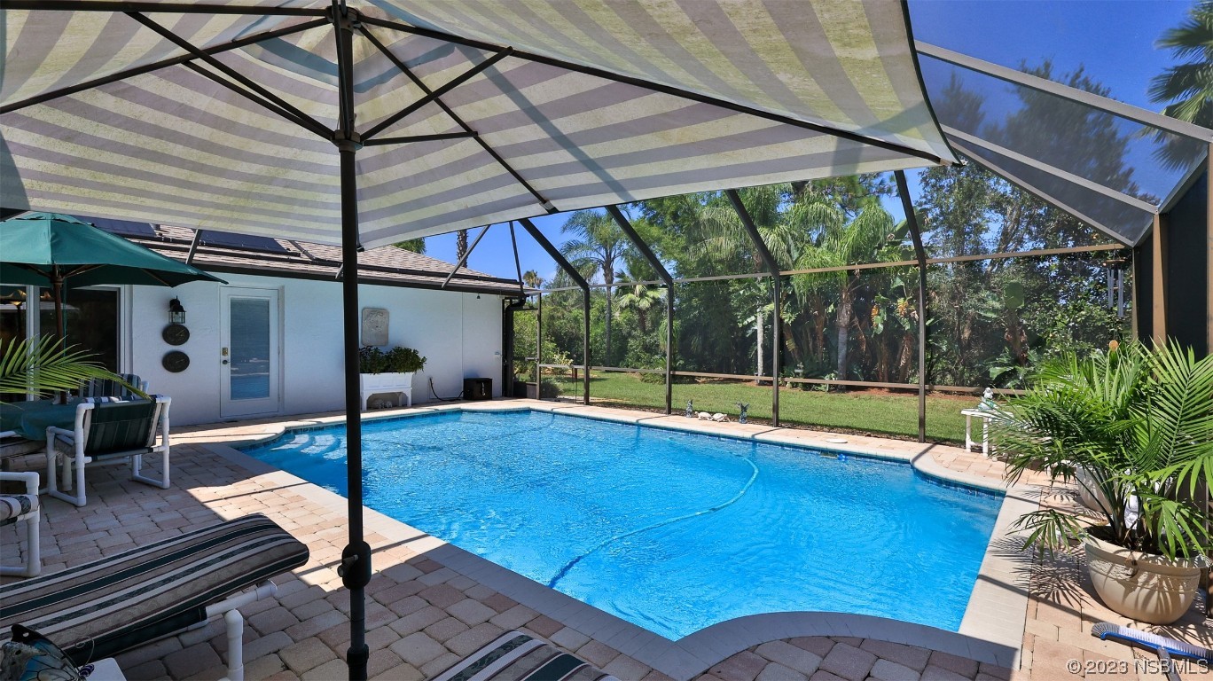 160 Packwood Road Edgewater, FL 32141 - Photo 27 of 31 a view of backyard with swimming pool and table