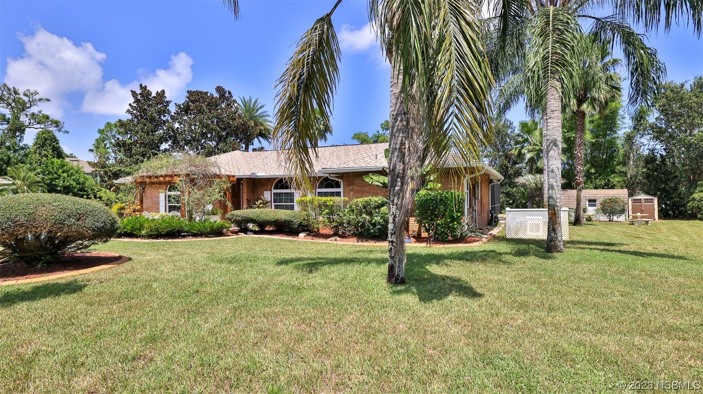 160 Packwood Road Edgewater, FL 32141 - Photo 3 of 31 a front view of a house with a yard