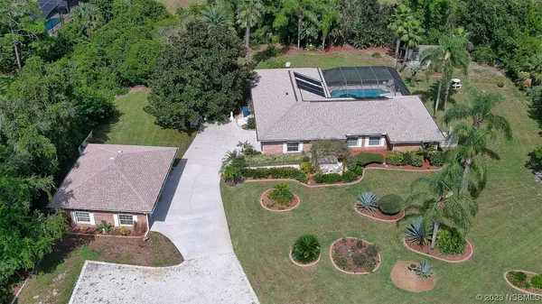 an aerial view of a house with outdoor space