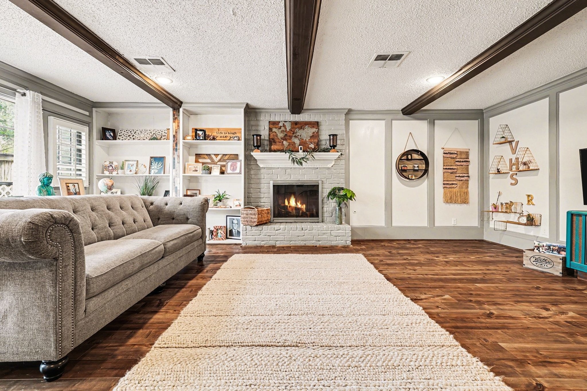 9530 Arcade Drive Spring, TX 77379 - Photo 12 of 37 Charming living room showcases custom built-ins, exposed ceiling beams, and a cozy fireplace—ideal for relaxing or entertaining guests.