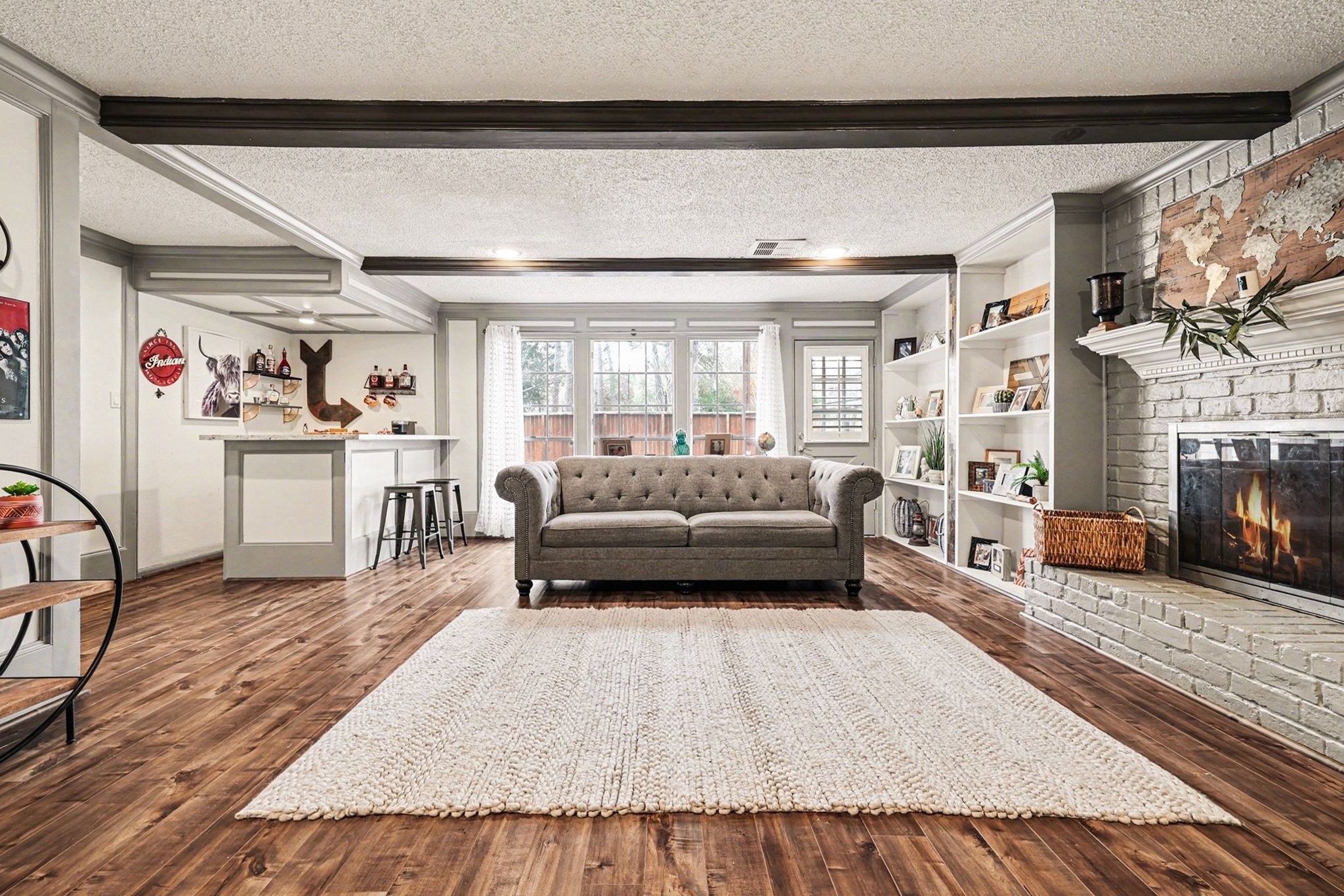 9530 Arcade Drive Spring, TX 77379 - Photo 14 of 37 This living room is enhanced by a wet bar, making it perfect for hosting gatherings.