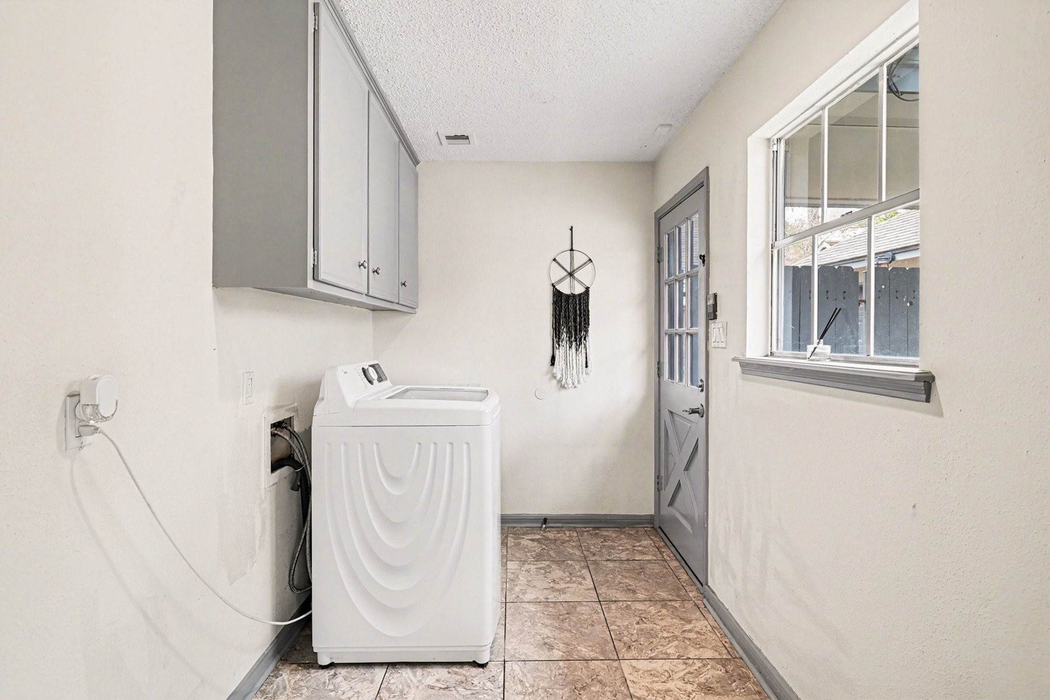 9530 Arcade Drive Spring, TX 77379 - Photo 23 of 37 Next to the kitchen is the big laundry room with access to the backyard.