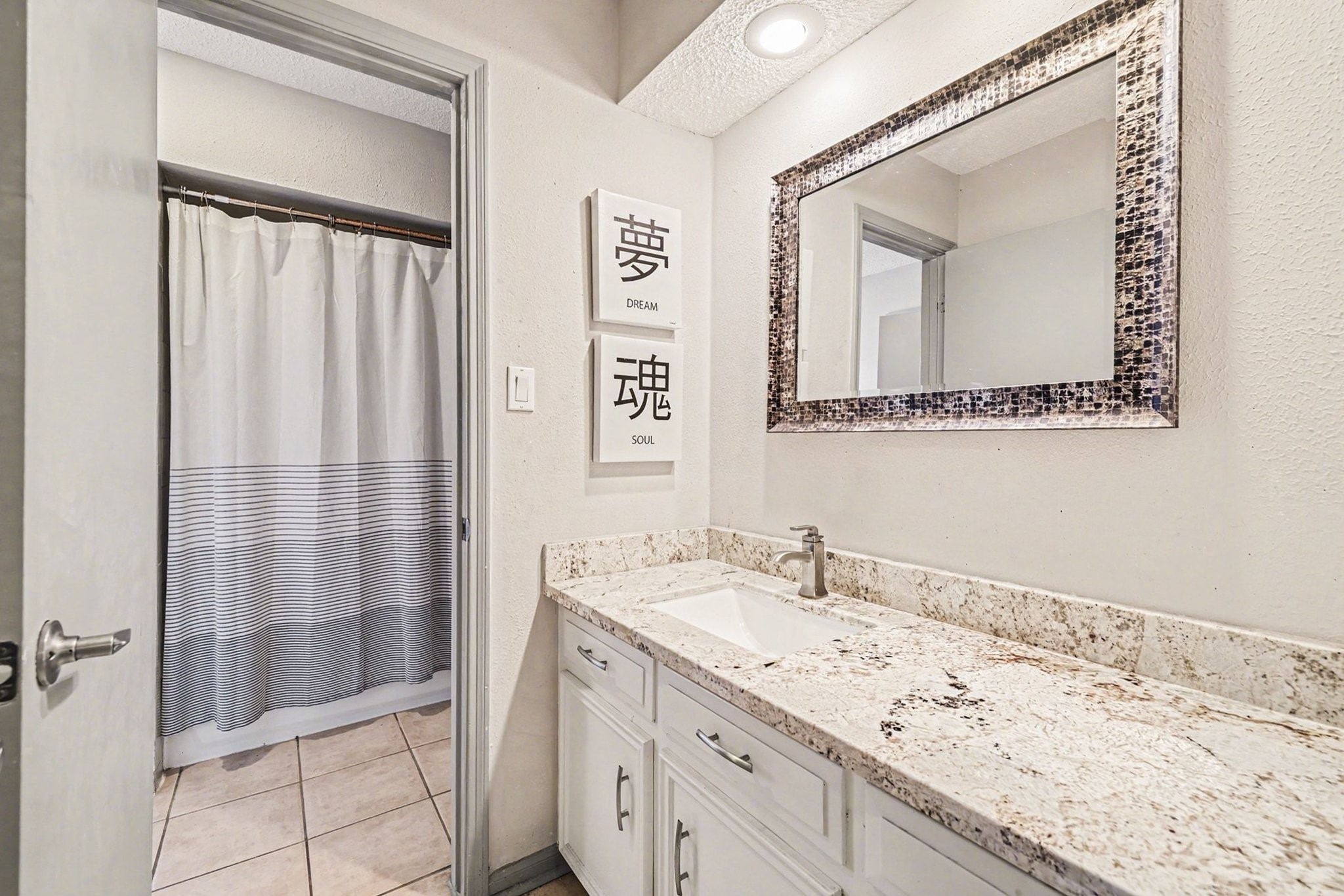 9530 Arcade Drive Spring, TX 77379 - Photo 25 of 37 Upstairs secondary bathroom offers great countertop space, a combination tub and shower, and lots of storage space.