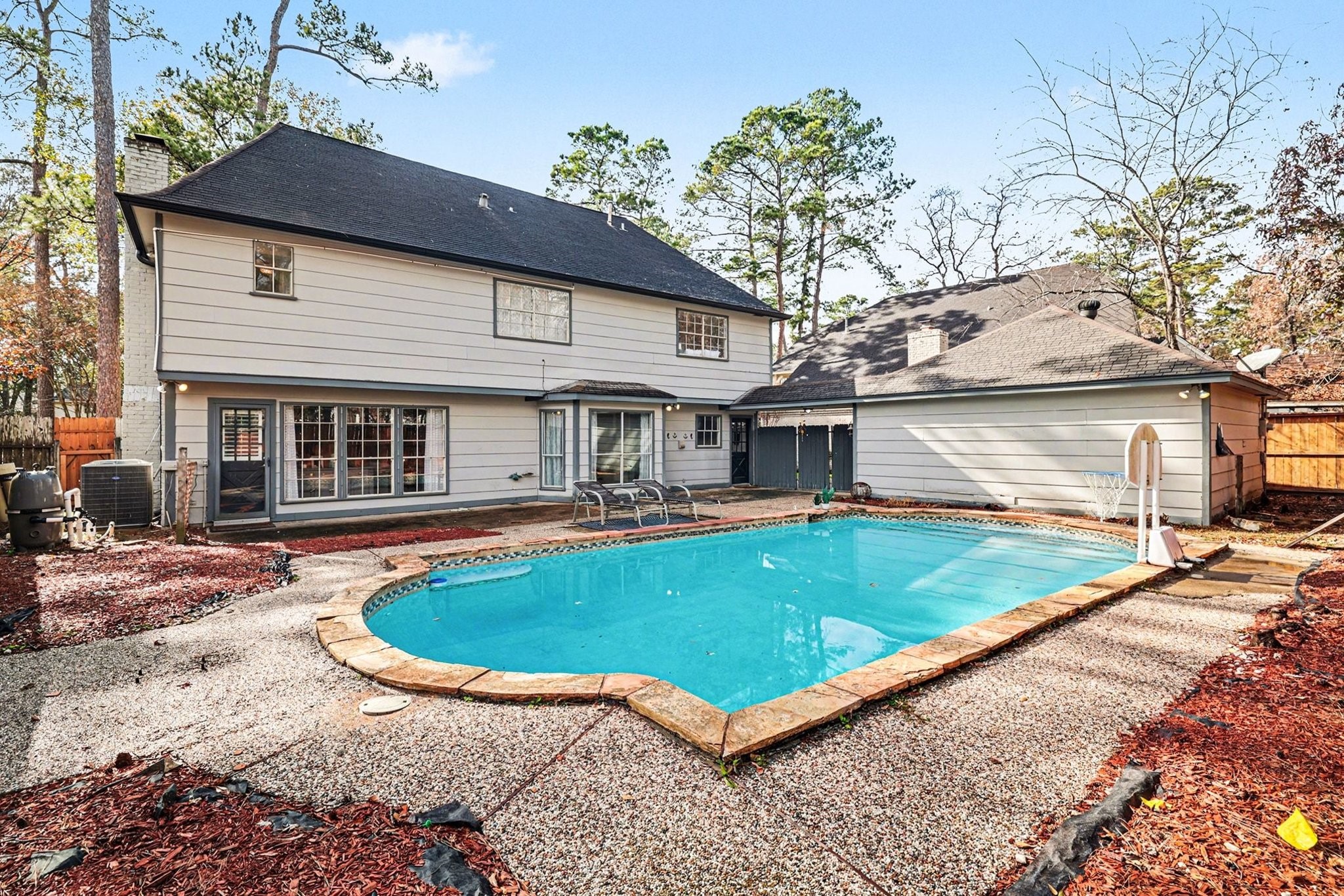 9530 Arcade Drive Spring, TX 77379 - Photo 32 of 37 Step outside to the backyard featuring a sparkling pool with an impressive 13-foot depth—perfect for summer fun and entertaining.