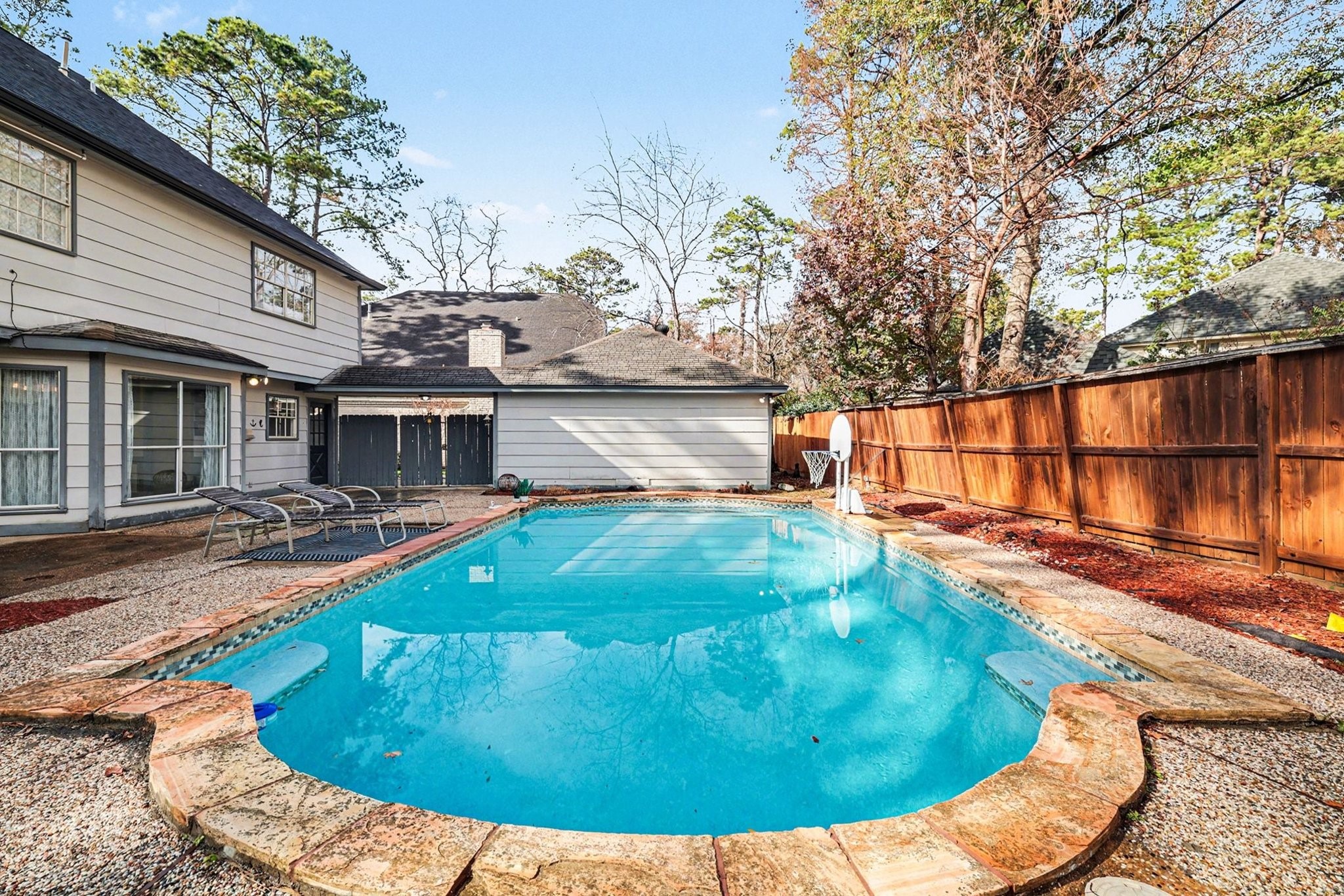 9530 Arcade Drive Spring, TX 77379 - Photo 33 of 37 Expansive look at the backyard pool for both fun-filled days and peaceful evenings.
