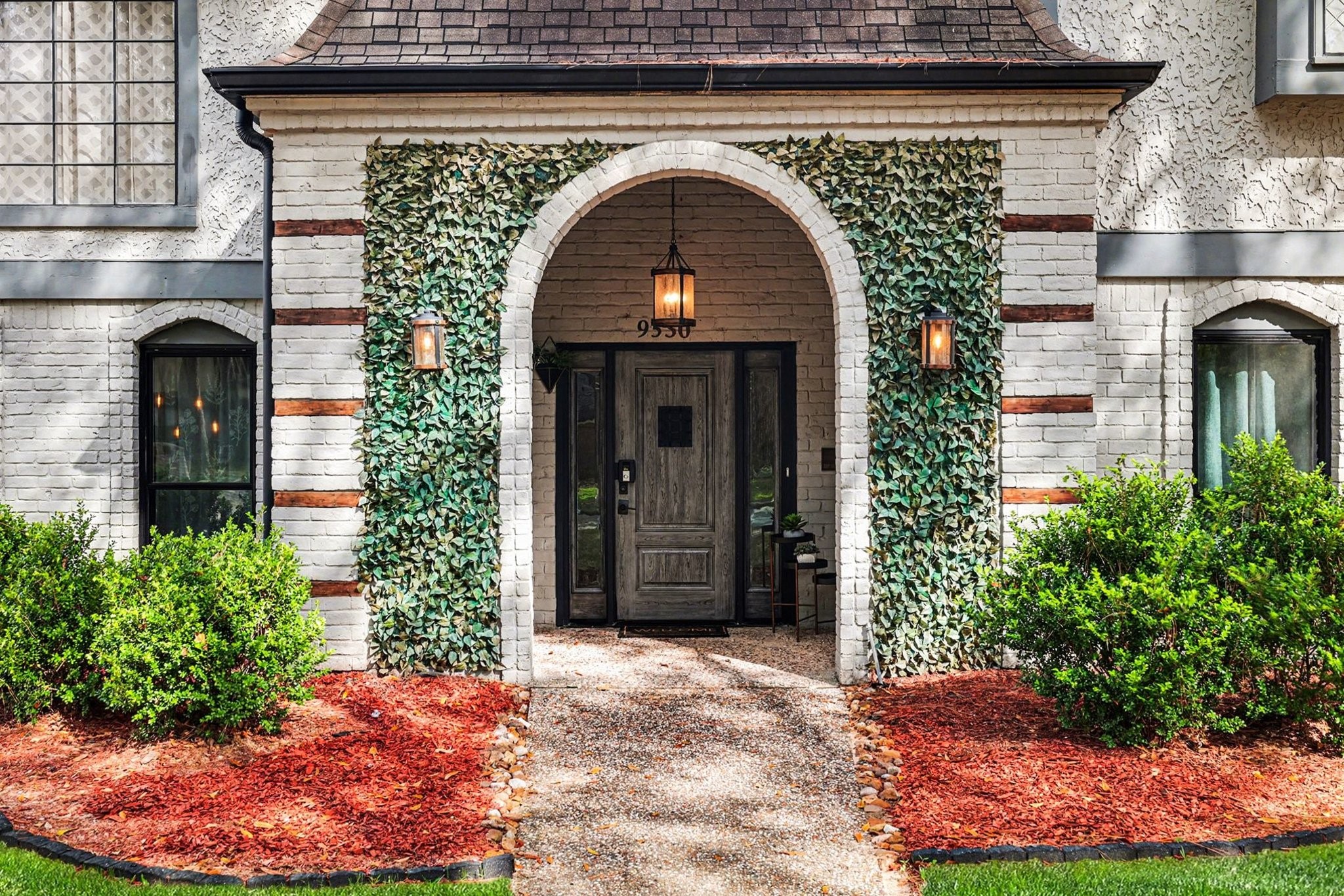 9530 Arcade Drive Spring, TX 77379 - Photo 5 of 37 Beautiful covered entry with an arched brick porch and decorative faux ivy accents—designed for curb appeal while remaining FHA and VA friendly with no maintenance concerns.