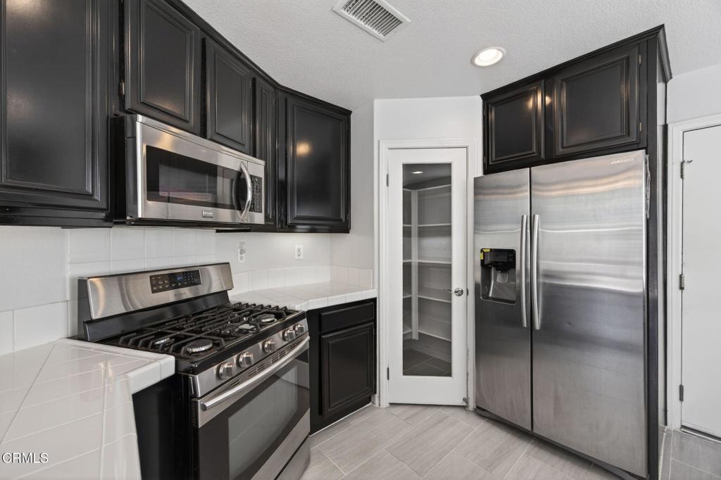 5331 Davidson Drive Oxnard, CA 93033 - Photo 14 of 38 a kitchen with stainless steel appliances and granite countertop a stove top oven