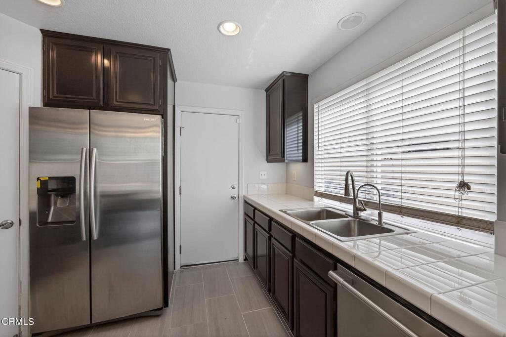 5331 Davidson Drive Oxnard, CA 93033 - Photo 15 of 38 a kitchen with kitchen island granite countertop a sink and refrigerator
