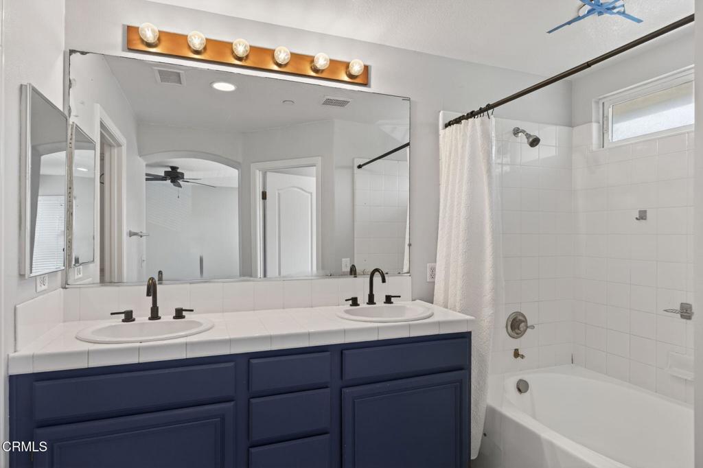 5331 Davidson Drive Oxnard, CA 93033 - Photo 26 of 38 a bathroom with a double vanity sink and a bathtub
