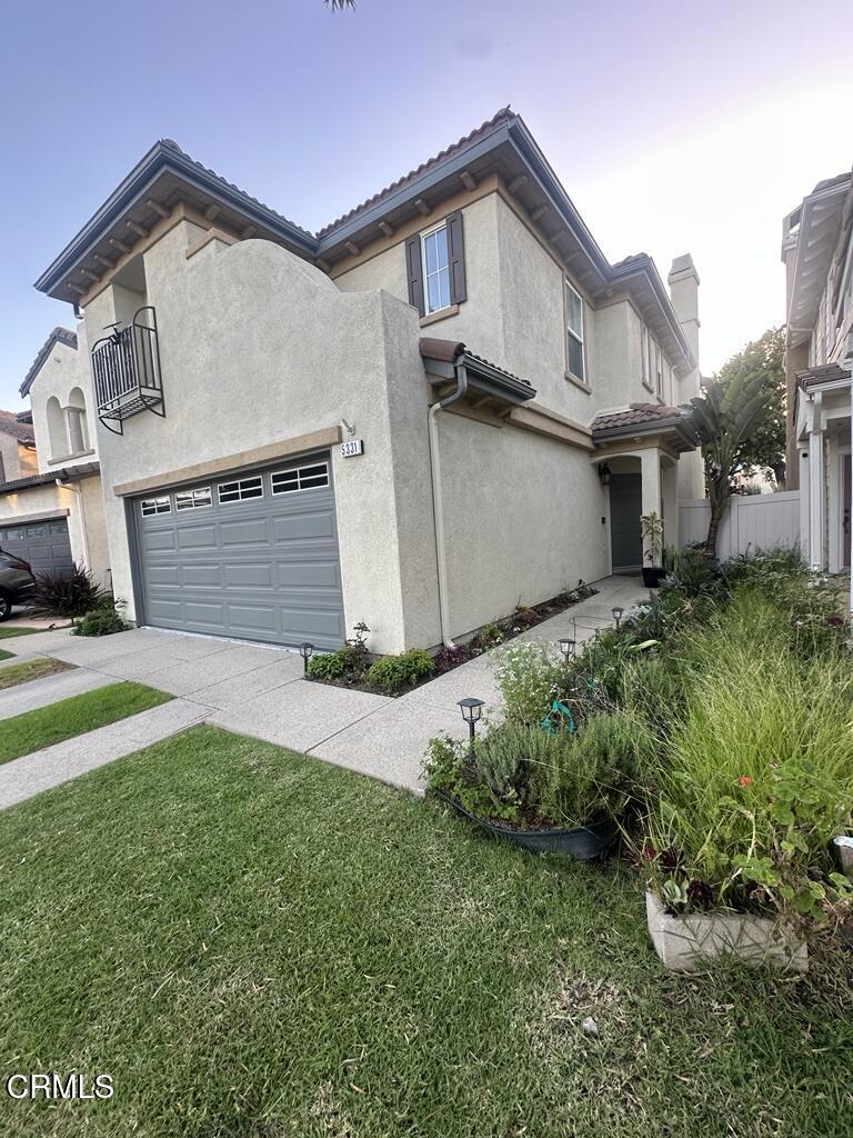 5331 Davidson Drive Oxnard, CA 93033 - Photo 7 of 38 a front view of a house with a yard and garage