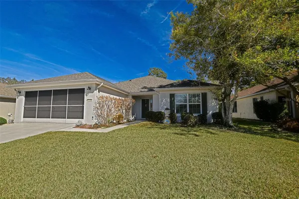 a front view of a house with a yard and seating space