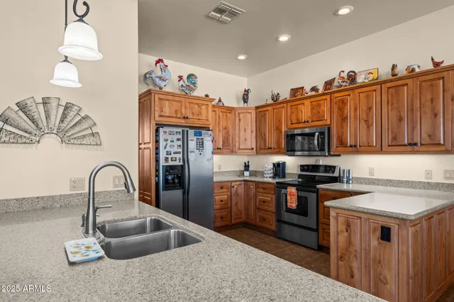 a kitchen with granite countertop a stove top oven a sink dishwasher and cabinets with wooden floor