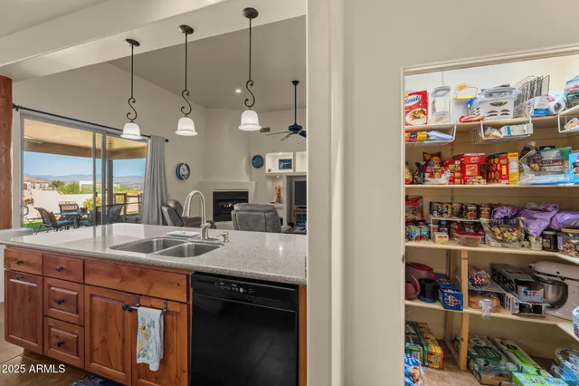 a kitchen with stainless steel appliances granite countertop a sink dishwasher and a refrigerator with a large window