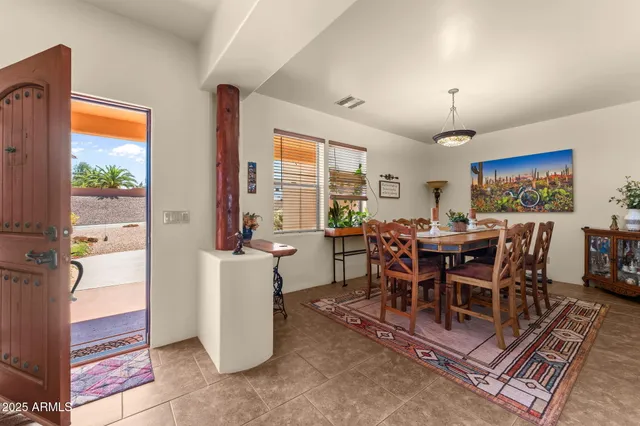 a dining room with furniture and window