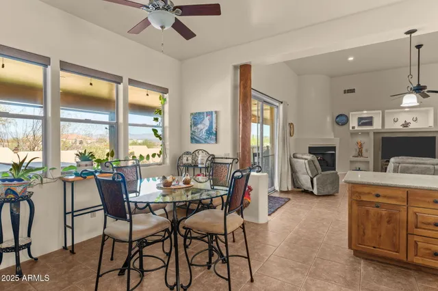 a dining room with furniture and a large window