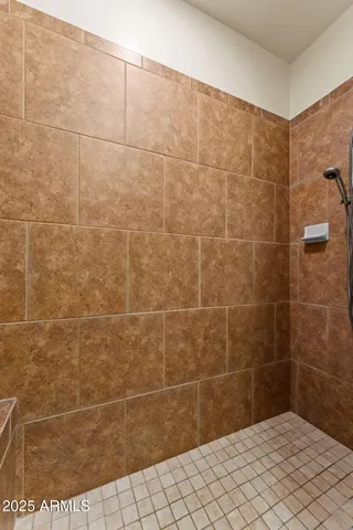a bathroom with a granite countertop sink a large mirror and a shower