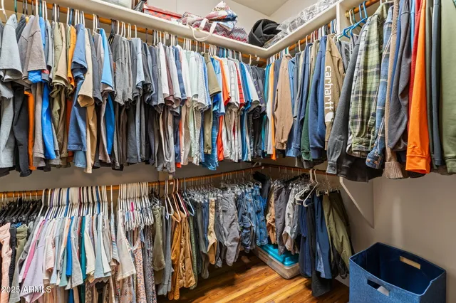 a bedroom with a bed couch and a window