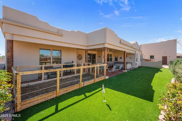 a view of a house with a backyard porch and sitting area