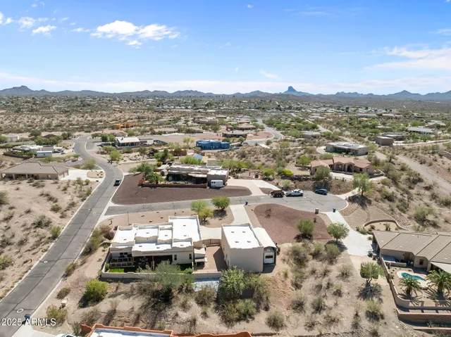 an aerial view of residential houses with outdoor space and trees