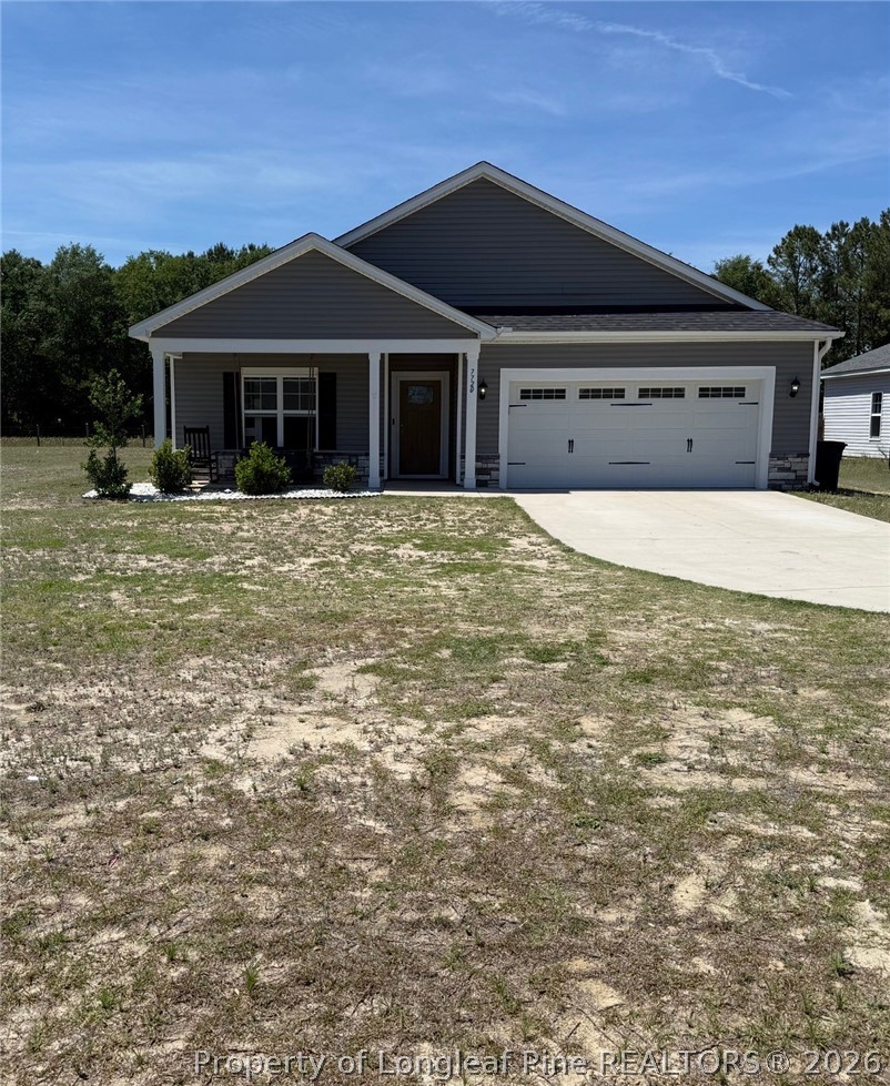 7720 Rufus Johnson Road Fayetteville, NC 28306 - Photo 1 of 50 a front view of a house with a garden and yard