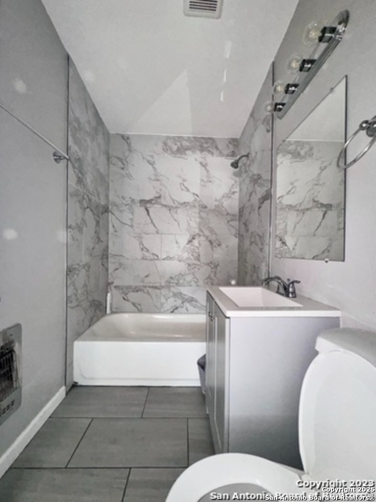 139 Crawford Road San Antonio, TX 78223 - Photo 12 of 13 a bathroom with a toilet a sink and bathtub
