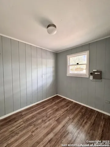 a view of a room with wooden floor