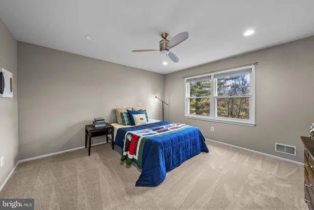 a bathroom with a granite countertop sink a toilet a mirror and shower