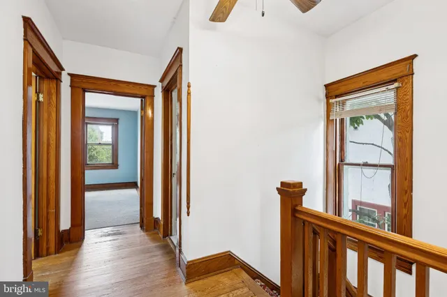 a view of a hallway with paintings on the wall