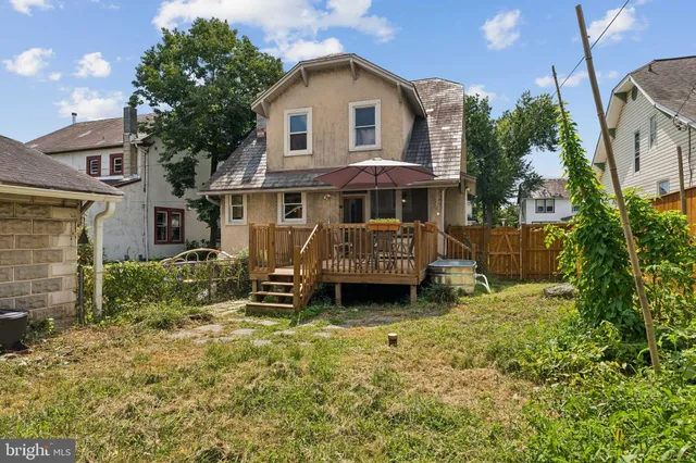 a small garden with a chair and a window