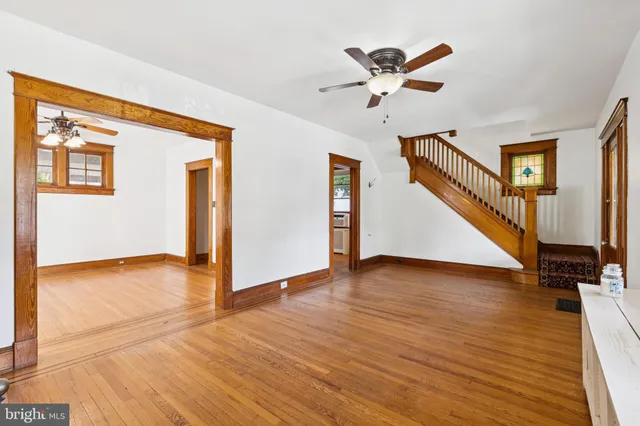 a living room with fireplace and a wooden floor