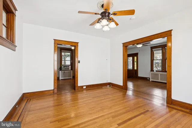 an empty room with wooden floor and a window