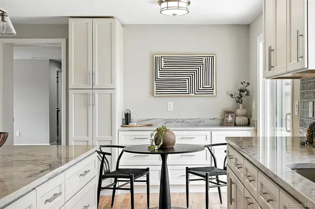 a view of a dining room with furniture and chandelier