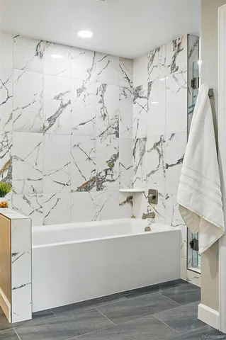 a bathroom with a bathtub and shower