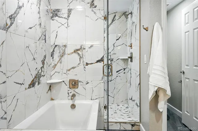 a bathroom with a bathtub and shower