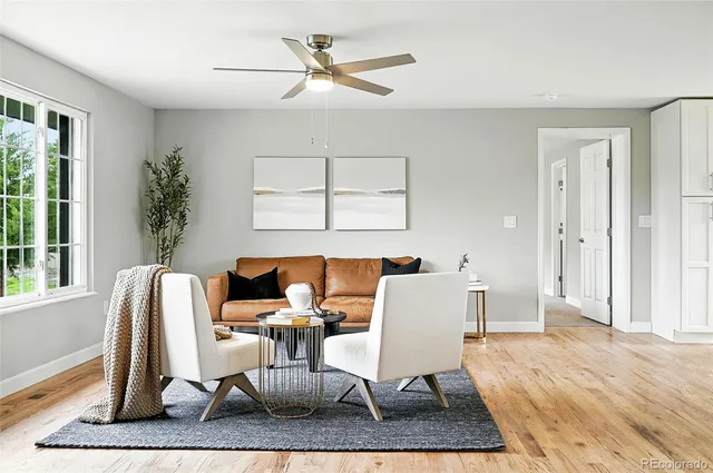 a dining room with wooden floor and a rug