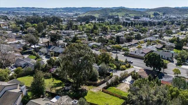 an aerial view of residential house and sandy dunes