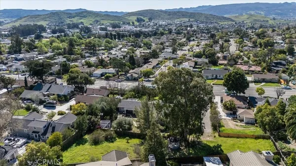 an aerial view of residential house with green space
