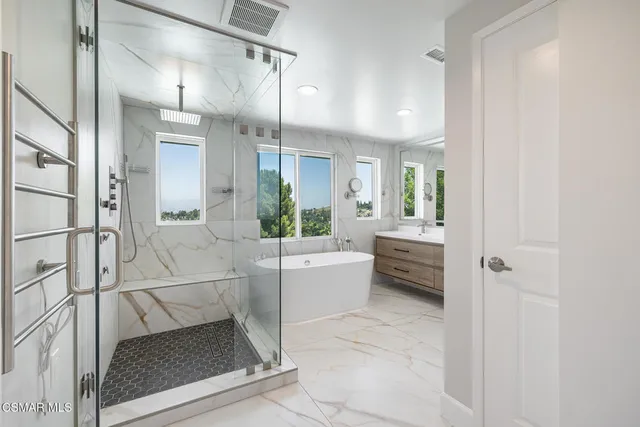 a bathroom with a tub shower sink and mirror