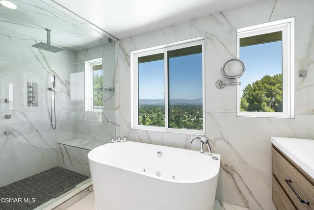 a white bath tub sitting next to a white sink