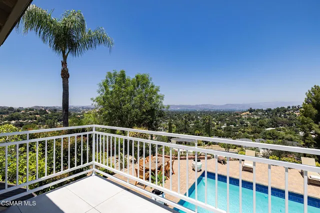 a view of a balcony with wooden fence