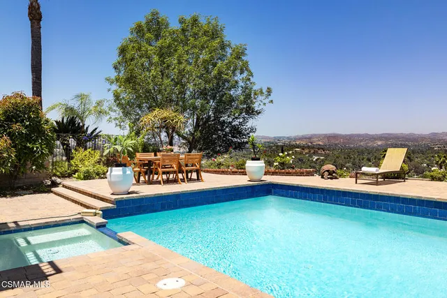 swimming pool view with a outdoor seating