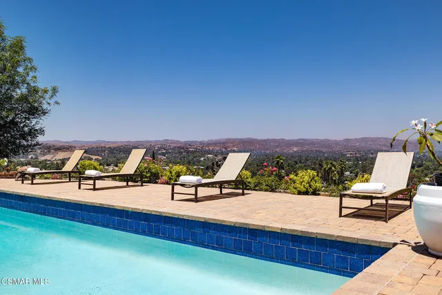 a view of a swimming pool with a lounge chair