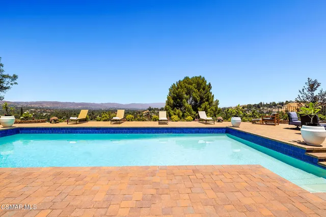 a view of a swimming pool with an ocean view