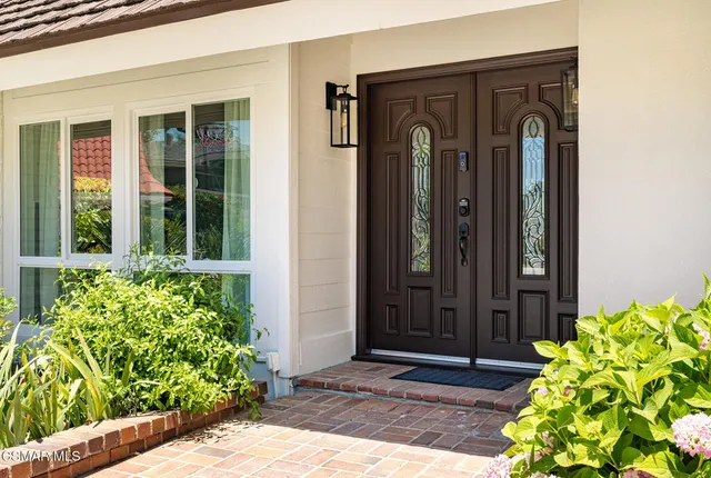 a front view of a house with a blue plant
