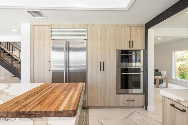 a bedroom with a bed and a view of kitchen