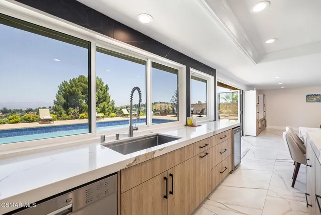 a kitchen with lots of counter top space and a sink