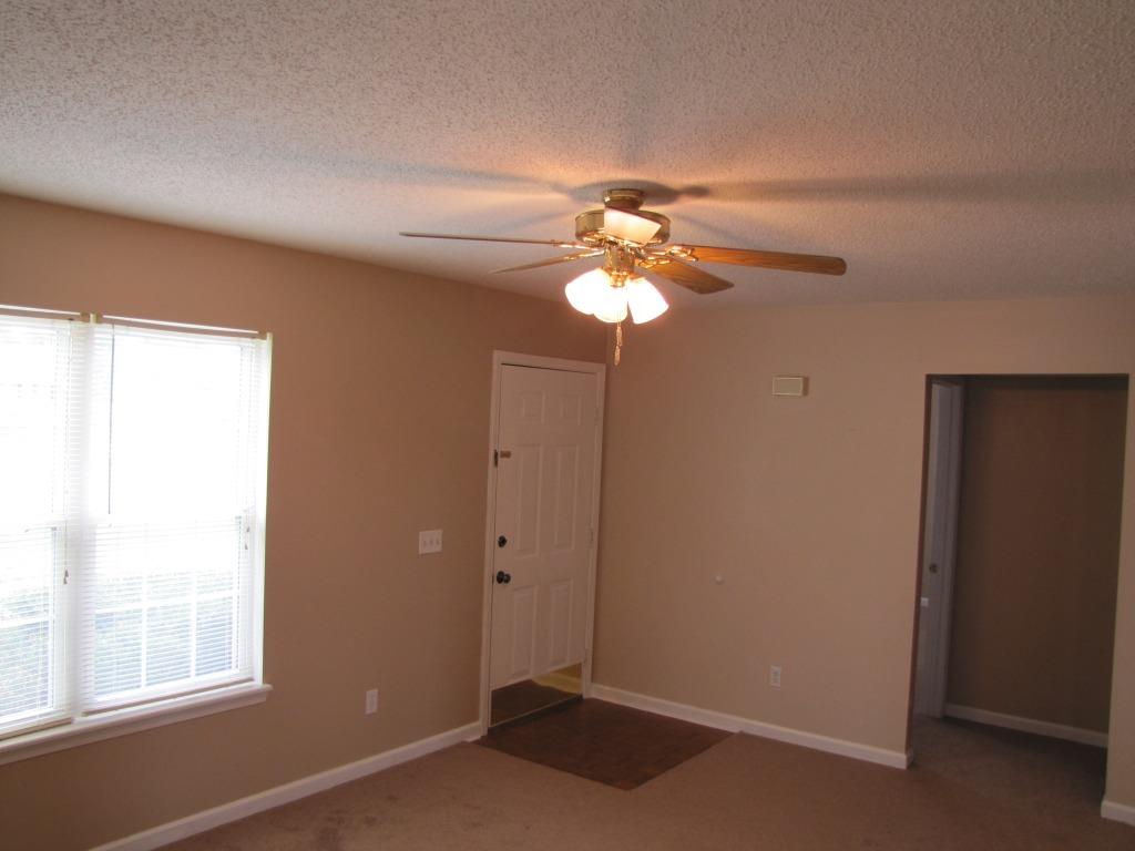 111 Miranda Road Cadiz, KY 42211 - Photo 2 of 15 an empty room with windows and chandelier fan